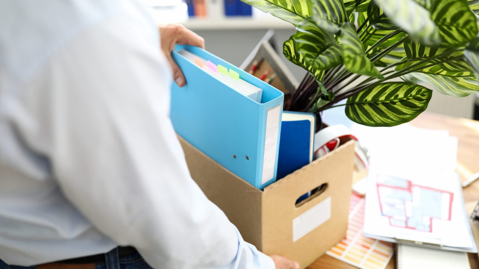 Businessman got fired during covid economy recession and taking his property out from office close-up