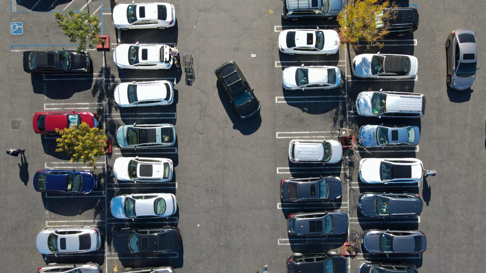 Aerial top view of parking lot with many cars from above, city transportation and urban concept