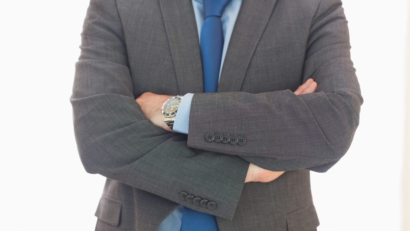 Close up of a business man crossing his arms in an office